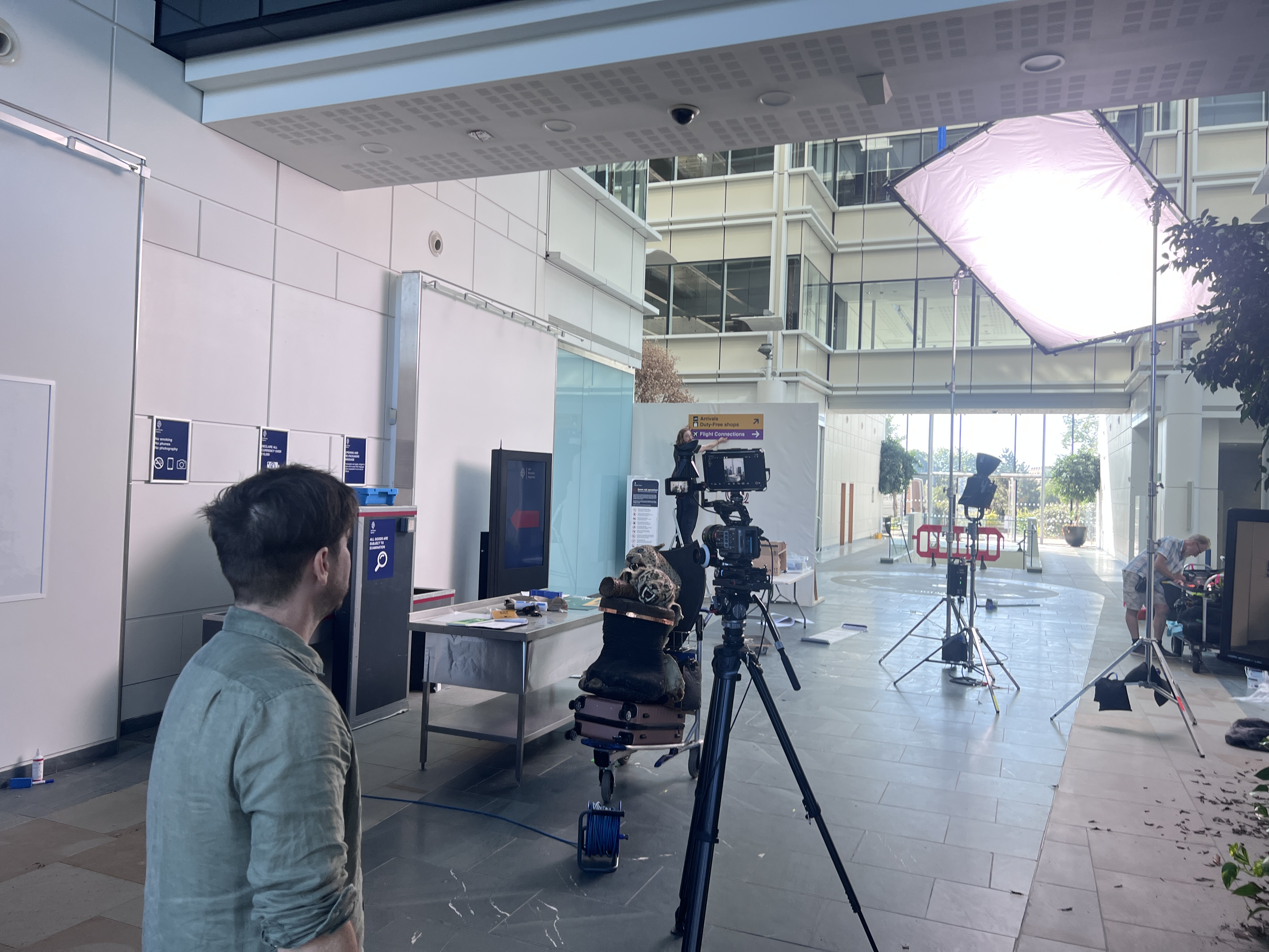 Early morning set build at 980 Great West Road – lighting rig and airport set dressing in progress, Nothing to Declare, 2026